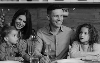 Smiling family enjoying quality time together at dining table in cozy kitchen.